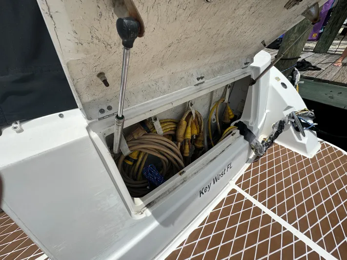  Yacht Photos Pics Storage compartment on 2007 Sea Ray 36 Sedan Bridge, containing cables and hoses, Key West, FL.