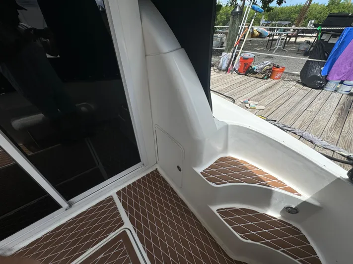  Yacht Photos Pics 2007 Sea Ray 36 Sedan Bridge boat deck with wood accents and dock view.