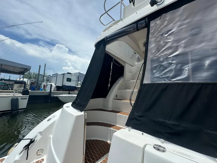  Yacht Photos Pics 2007 Sea Ray 36 Sedan Bridge yacht docked, featuring steps and black canvas cover.