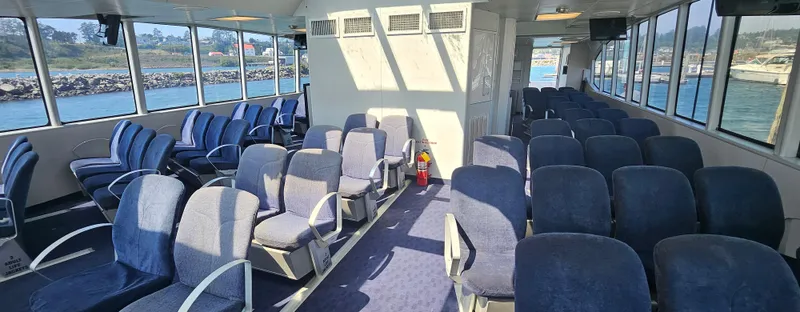 Billie J Yacht Photos Pics Interior of 2008 Custom High Speed 70pax COI Passenger vessel with blue seating.