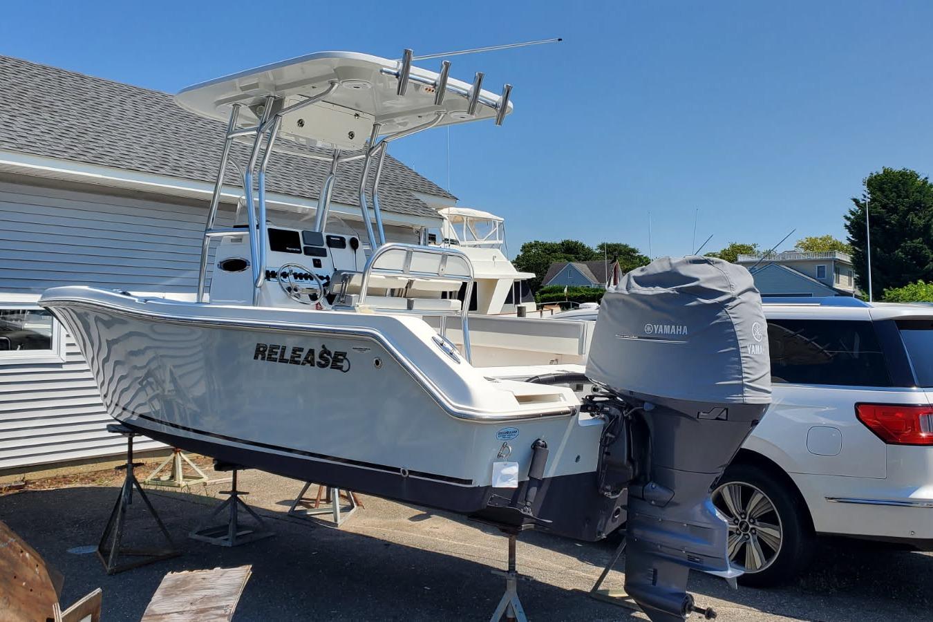 2018 Release 208RX boat with Yamaha engine, parked outdoors on stands.
