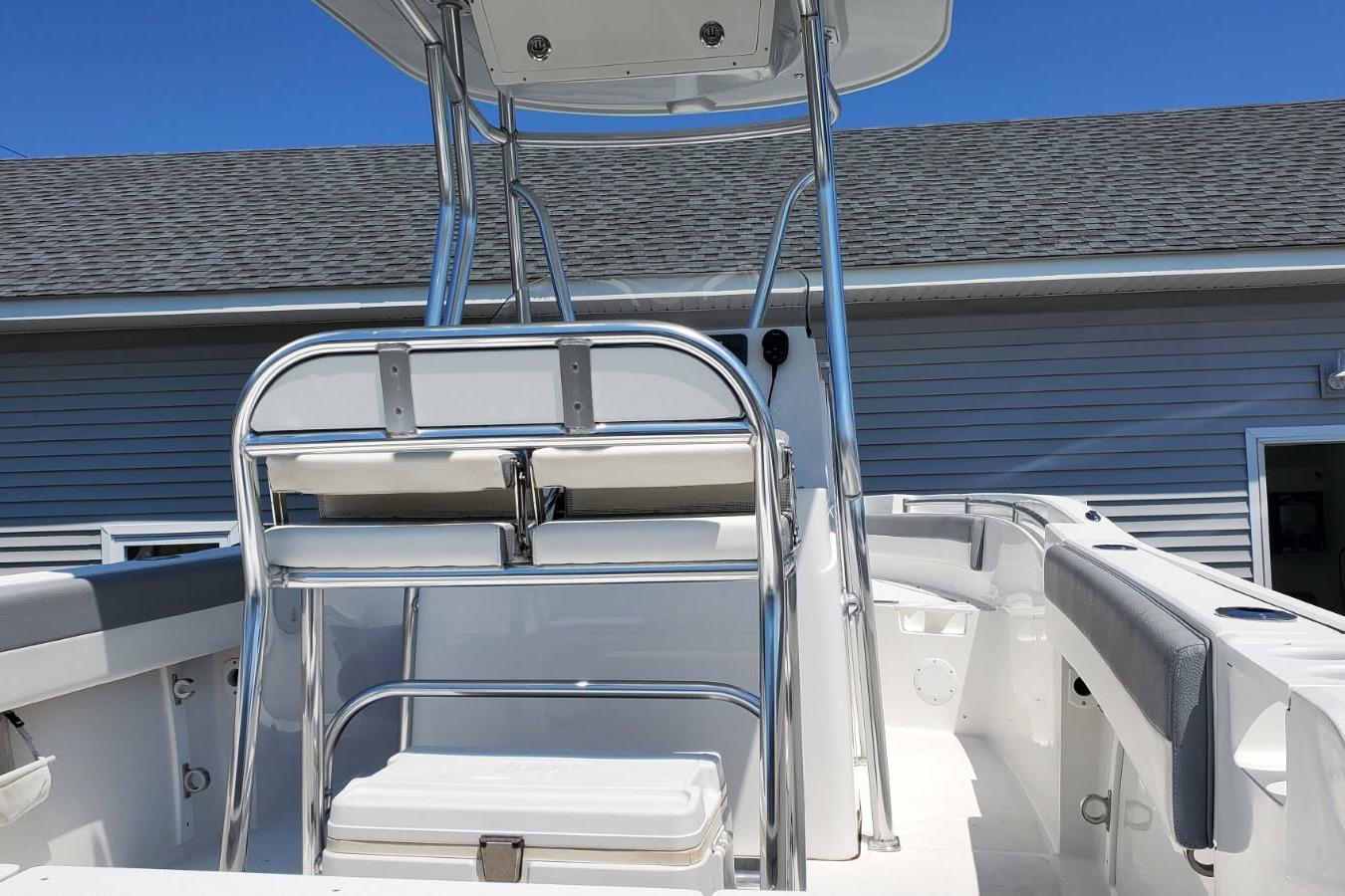 2018 Release 208RX boat interior with seating and metal framework, under clear blue sky.
