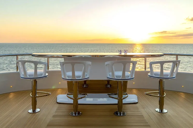  Yacht Photos Pics Luxury Benetti B.NOW yacht deck with bar stools, ocean view, and sunset, 2022 model.