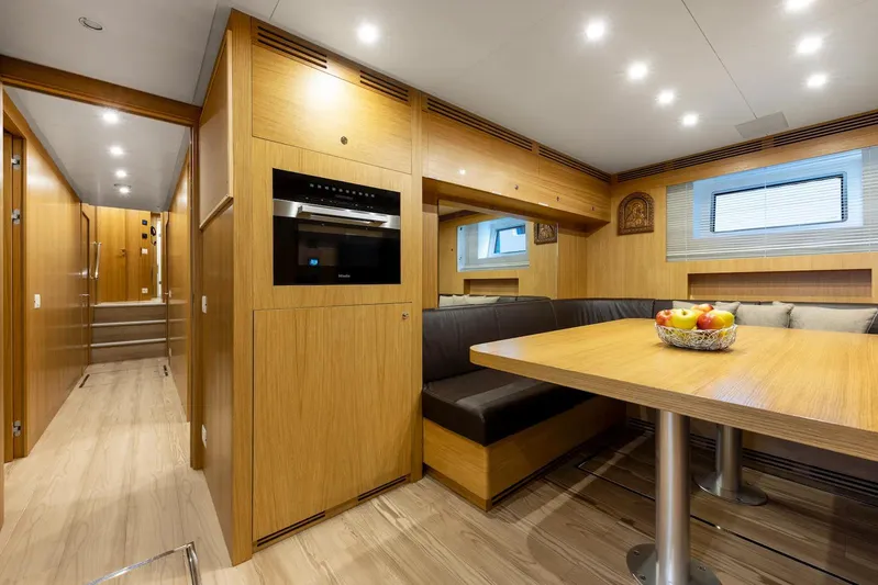  Yacht Photos Pics Luxurious interior of 2022 Benetti B.NOW yacht with modern dining area and wood finishes.