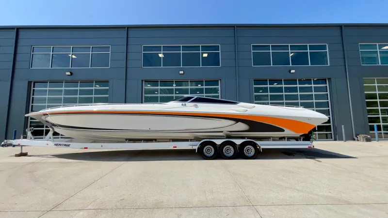  Yacht Photos Pics 2003 Fountain 47 Lightning boat on trailer, parked outside industrial building.