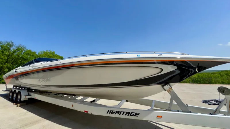  Yacht Photos Pics 2003 Fountain 47 Lightning speedboat on trailer under clear blue sky.