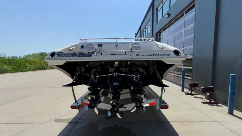  Yacht Photos Pics 2003 Fountain 47 Lightning boat, rear view, parked outside a building.