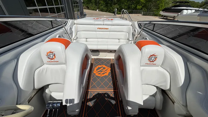  Yacht Photos Pics 2003 Fountain 47 Lightning boat interior with white and orange seating, sleek design.