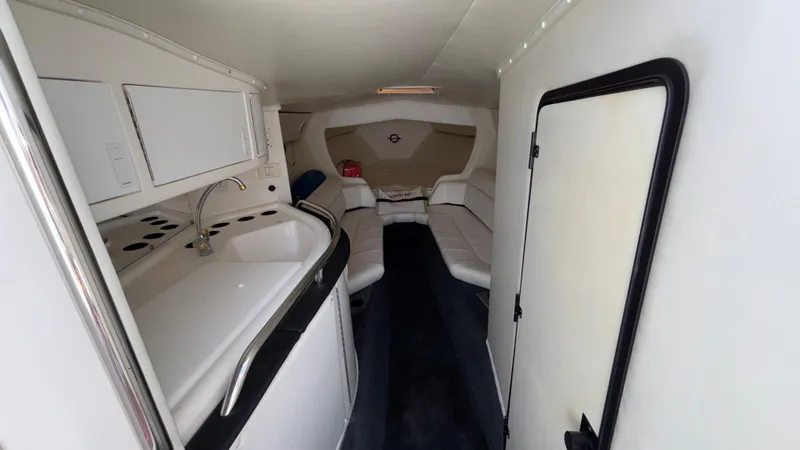  Yacht Photos Pics 2003 Fountain 47 Lightning boat interior with kitchenette and seating area.