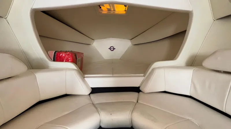  Yacht Photos Pics 2003 Fountain 47 Lightning boat interior with white seating and storage compartment.