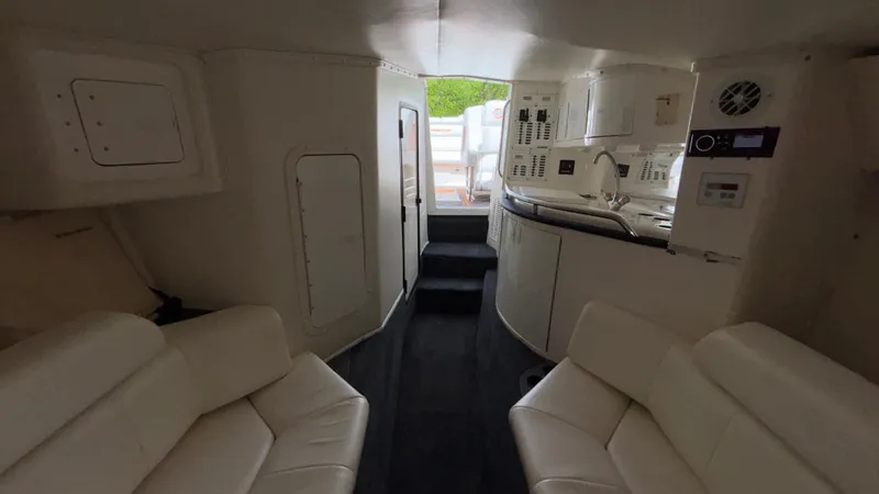  Yacht Photos Pics Interior of 2003 Fountain 47 Lightning boat with white seating and compact kitchen area.