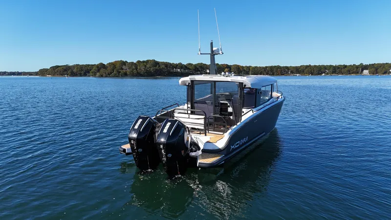  Yacht Photos Pics 2023 XO Boats EXPLR 10 Sport Plus on calm water, rear view.