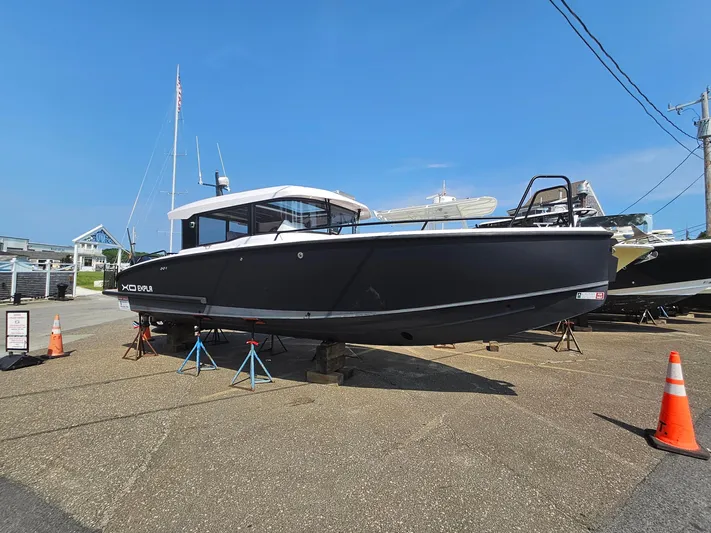  Yacht Photos Pics 2023 XO Boats EXPLR 10 Sport Plus on display, black hull, docked on land.