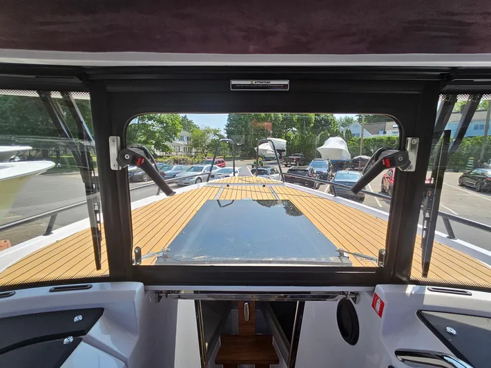  Yacht Photos Pics 2023 XO Boats EXPLR 10 Sport Plus cockpit view with teak deck and windshield.