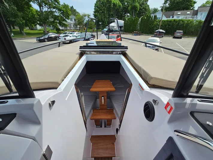  Yacht Photos Pics 2023 XO Boats EXPLR 10 Sport Plus interior with wooden steps and seating.