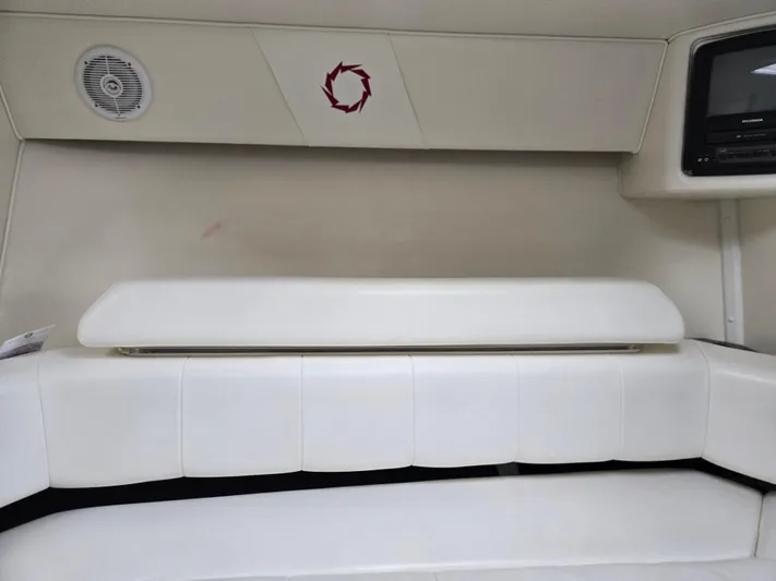  Yacht Photos Pics Interior of 2004 Fountain 47 Lightning boat with white seating and built-in speaker.