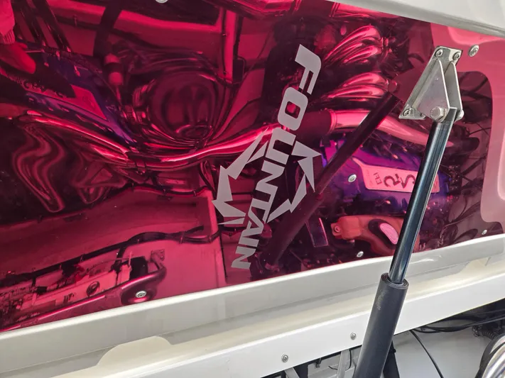  Yacht Photos Pics 2004 Fountain 47 Lightning boat engine with reflective red cover and logo.