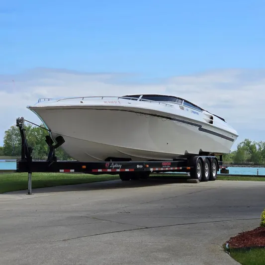  Yacht Photos Pics 2004 Fountain 47 Lightning boat on a trailer by a lake.