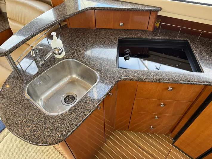  Yacht Photos Pics 2006 Meridian 391 Sedan yacht kitchen with granite countertop and stainless steel sink.