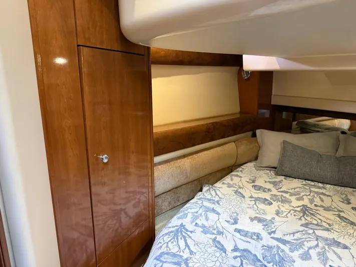  Yacht Photos Pics Luxurious cabin interior of 2006 Meridian 391 Sedan with wood paneling and cozy bedding.