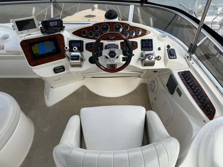  Yacht Photos Pics Helm of 2006 Meridian 391 Sedan with modern navigation equipment and luxurious white seating.