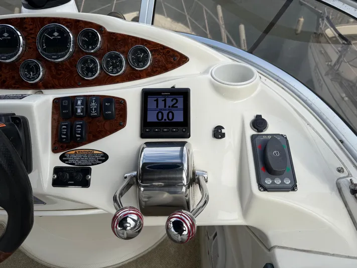  Yacht Photos Pics Control panel of a 2006 Meridian 391 Sedan boat with gauges and throttle.