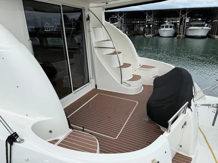  Yacht Photos Pics 2006 Meridian 391 Sedan yacht deck with spiral staircase and covered seating area.