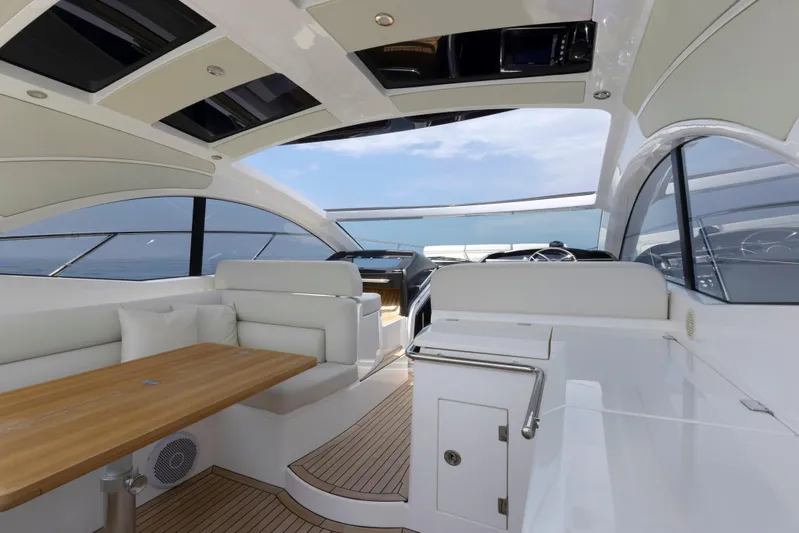  Yacht Photos Pics Luxurious interior of 2017 Sunseeker San Remo yacht with elegant seating and wooden table.