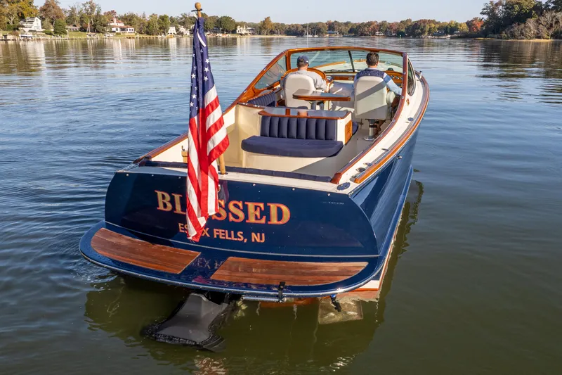 Blessed Yacht Photos Pics 2003 Hinckley Talaria 29 Runabout on calm water, displaying American flag.