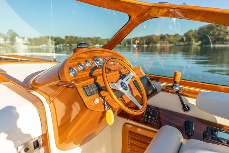 Blessed Yacht Photos Pics 2003 Hinckley Talaria 29 Runabout cockpit with wooden steering wheel and dashboard controls.