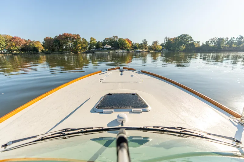 Blessed Yacht Photos Pics Bow view of 2003 Hinckley Talaria 29 Runabout on calm lake with autumn trees.