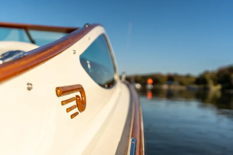 Blessed Yacht Photos Pics 2003 Hinckley Talaria 29 Runabout, elegant design, wooden trim, on calm water.