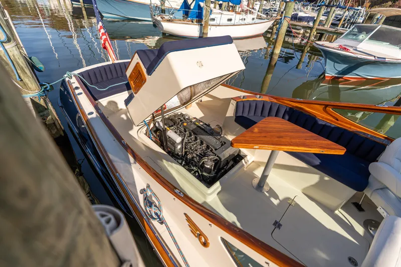 Blessed Yacht Photos Pics 2003 Hinckley Talaria 29 Runabout with open engine compartment, docked at marina.