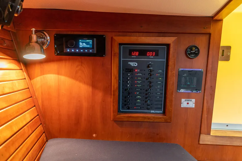 Blessed Yacht Photos Pics Interior of 2003 Hinckley Talaria 29 Runabout with control panel and wooden finish.