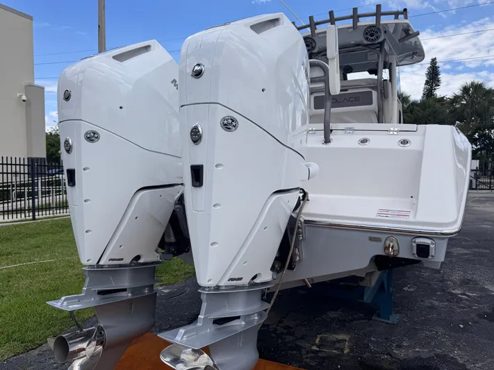 Call Today! 32 #55 Yacht Photos Pics 2025 Solace 32 CS boat with dual outboard engines, parked outdoors.