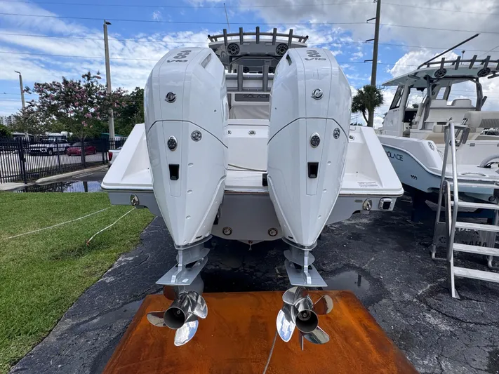 Call Today! 32 #55 Yacht Photos Pics 2025 Solace 32 CS boat with dual outboard engines, displayed outdoors on a sunny day.