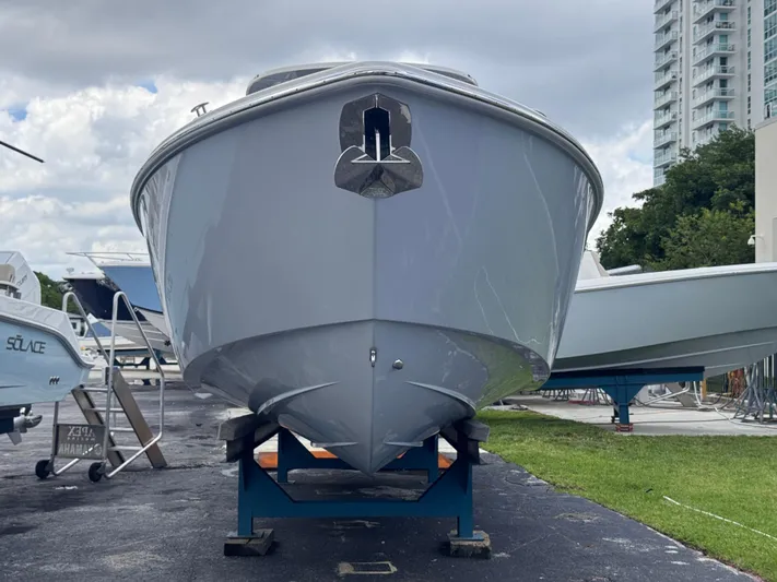 Call Today! 32 #55 Yacht Photos Pics 2025 Solace 32 CS boat on display, front view, with urban background.