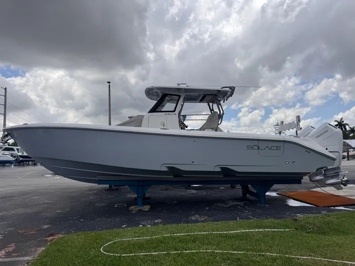 Call Today! 32 #55 Yacht Photos Pics 2025 Solace 32 CS boat on display under cloudy sky.