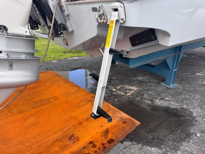 Call Today! 32 #55 Yacht Photos Pics 2025 Solace 32 CS boat with ladder on orange mat, docked on a stand.