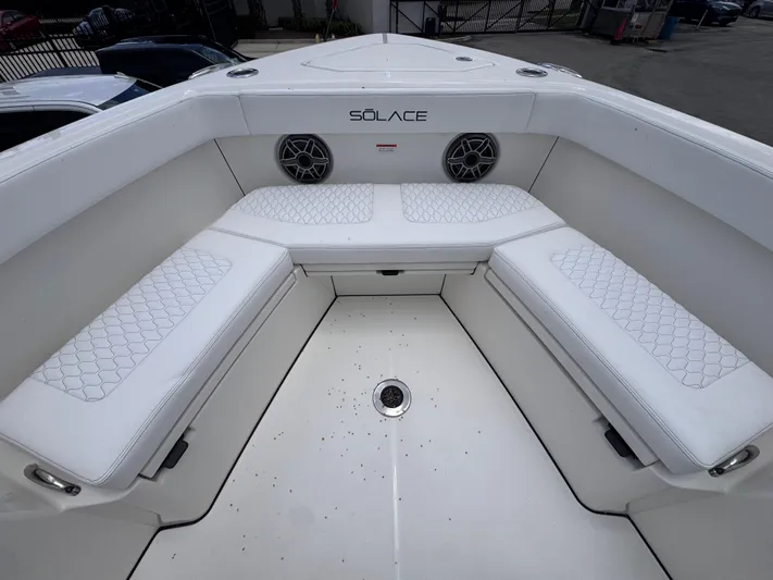 Call Today! 32 #55 Yacht Photos Pics Bow seating area of 2025 Solace 32 CS boat with white cushions and speakers.