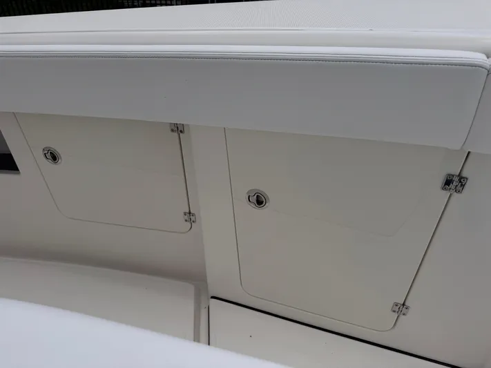 Call Today! 32 #55 Yacht Photos Pics Storage compartments on a 2025 Solace 32 CS boat, featuring sleek white design.