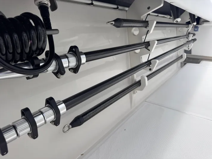 Call Today! 32 #55 Yacht Photos Pics Storage compartment with fishing rods in a 2025 Solace 32 CS boat.