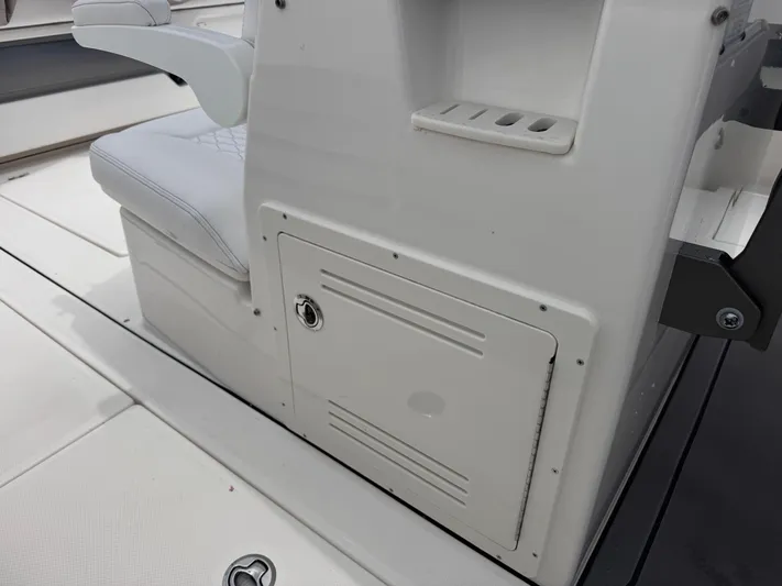 Call Today! 32 #55 Yacht Photos Pics 2025 Solace 32 CS boat interior with storage compartment and cushioned seating.