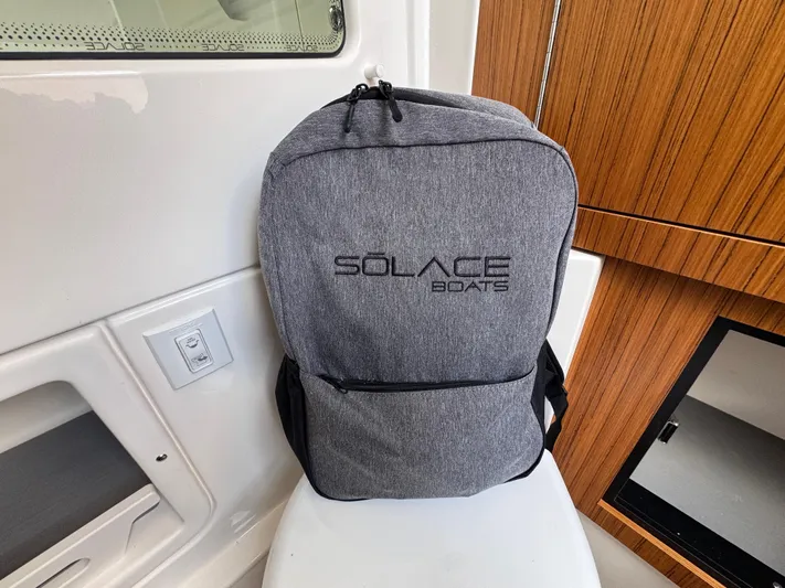 Call Today! 32 #55 Yacht Photos Pics Gray Solace Boats backpack inside 2025 Solace 32 CS cabin, featuring sleek wooden paneling.