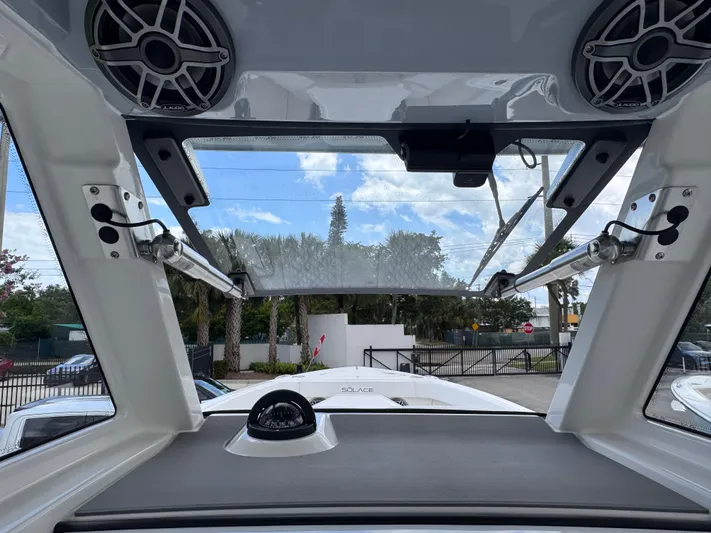 Call Today! 32 #55 Yacht Photos Pics Interior view of 2025 Solace 32 CS boat with open sunroof and speakers.