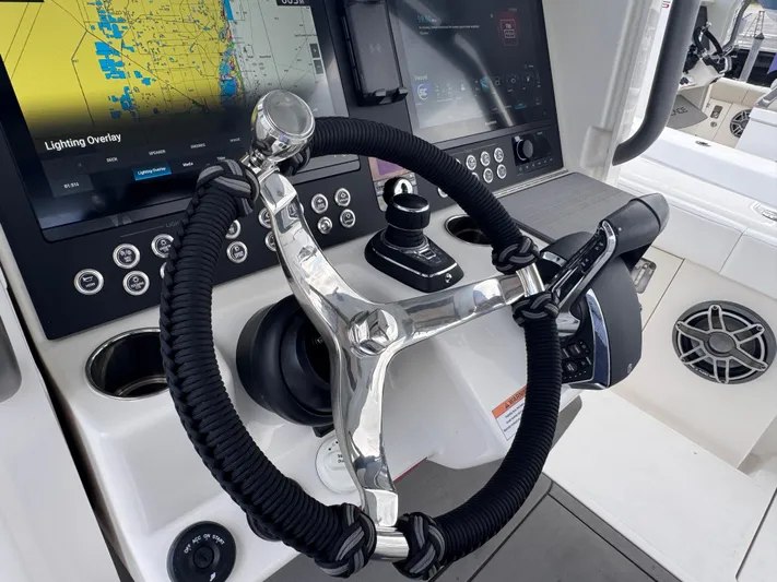 Call Today! 32 #55 Yacht Photos Pics Steering wheel and controls of 2025 Solace 32 CS boat with navigation screens.