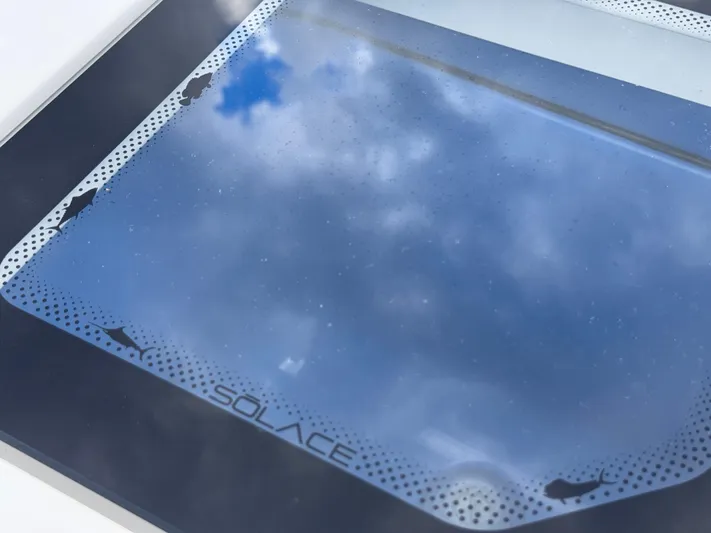 Call Today! 32 #55 Yacht Photos Pics Skylight view on Solace 32 CS 2025 boat, reflecting blue sky and clouds.