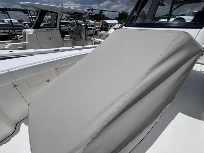 Call Today! 32 #55 Yacht Photos Pics 2025 Solace 32 CS boat with covered seating area, docked under a partly cloudy sky.