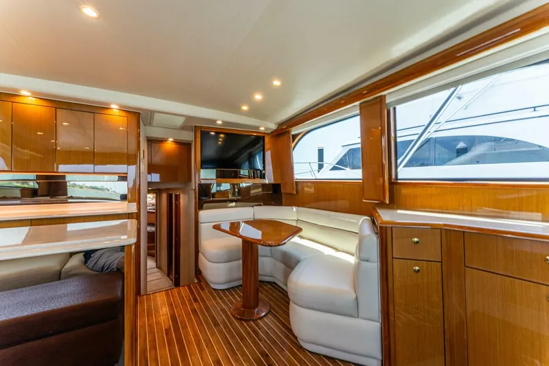 Wound Tight Yacht Photos Pics Luxurious interior of 2004 Viking 48 Convertible yacht with wood finishes and plush seating.