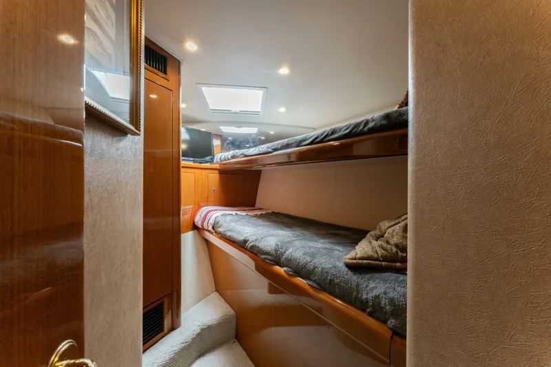 Wound Tight Yacht Photos Pics 2004 Viking 48 Convertible yacht interior with cozy bunk beds and wooden finish.
